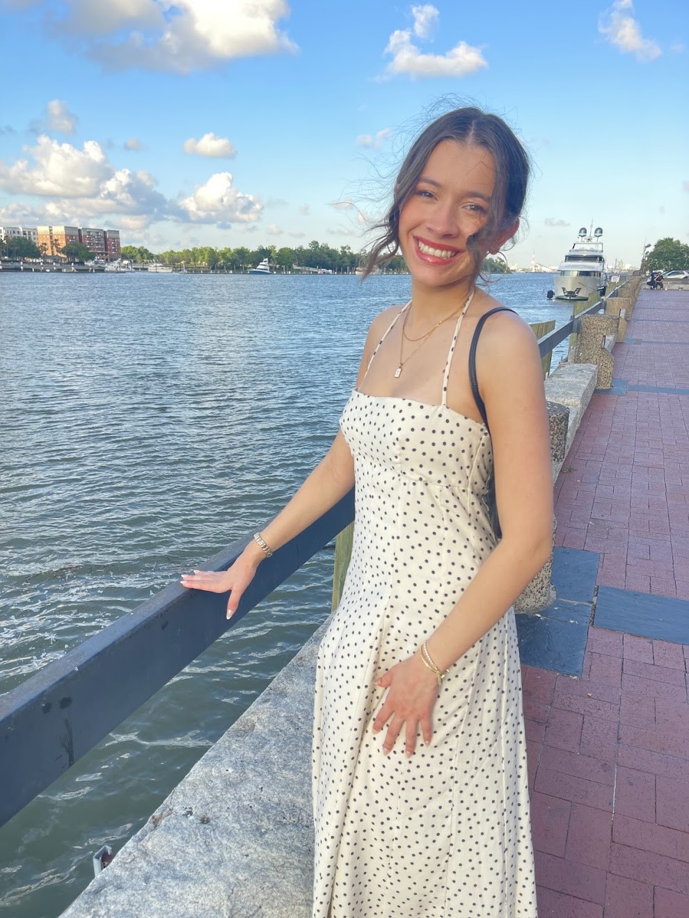 Tessa smiling beside the water